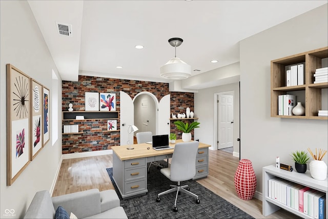 8602 Frontgate Ln, Indianapolis, IN 46256 - home office with brick wall, light wood-style floors, baseboards, and recessed lighting