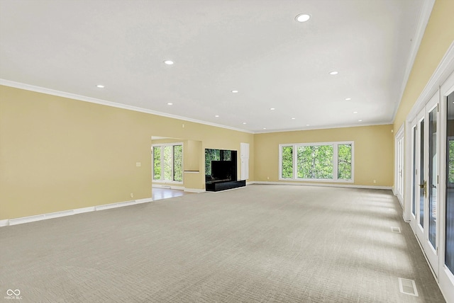 8602 Frontgate Ln, Indianapolis, IN 46256 - unfurnished living room with light carpet, recessed lighting, baseboards, plenty of natural light, and ornamental molding