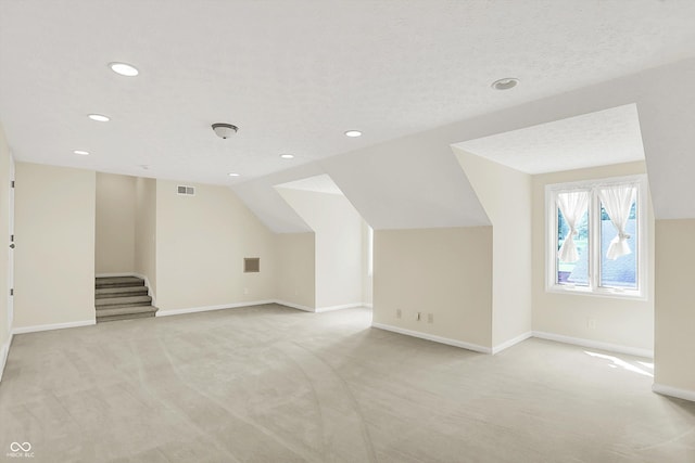 8602 Frontgate Ln, Indianapolis, IN 46256 - additional living space featuring light colored carpet, baseboards, recessed lighting, lofted ceiling, and stairs
