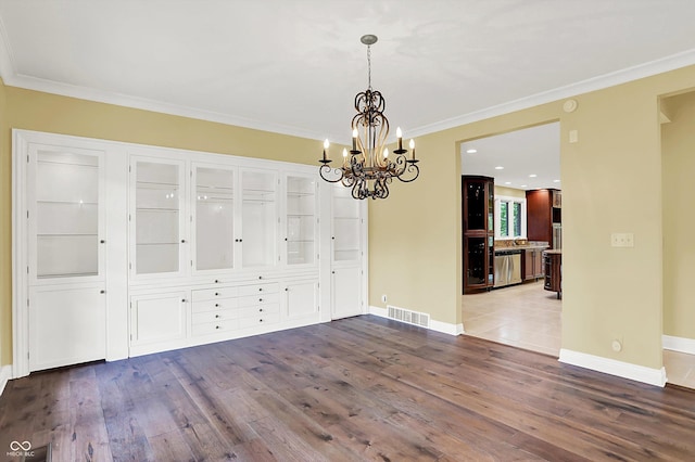 8602 Frontgate Ln, Indianapolis, IN 46256 - unfurnished dining area featuring a chandelier, dark wood-type flooring, ornamental molding, and baseboards
