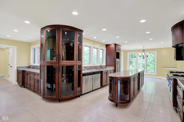 8602 Frontgate Ln, Indianapolis, IN 46256 - kitchen featuring healthy amount of natural light, recessed lighting, light stone countertops, appliances with stainless steel finishes, and a sink