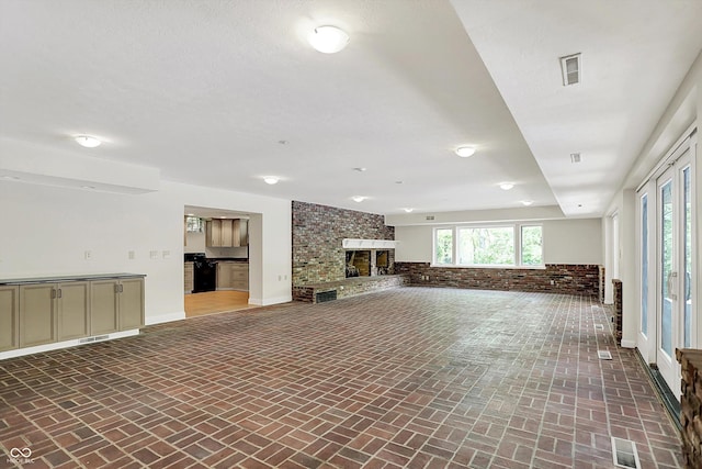 8602 Frontgate Ln, Indianapolis, IN 46256 - unfurnished living room with brick floors, a brick fireplace, and baseboards