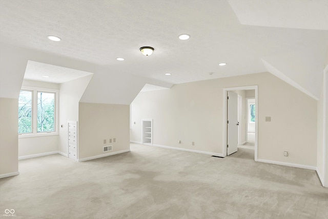8602 Frontgate Ln, Indianapolis, IN 46256 - additional living space with light colored carpet, vaulted ceiling, baseboards, and recessed lighting