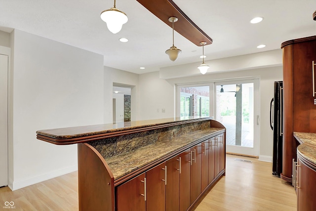 8602 Frontgate Ln, Indianapolis, IN 46256 - kitchen featuring light wood-style floors, baseboards, freestanding refrigerator, hanging light fixtures, and recessed lighting