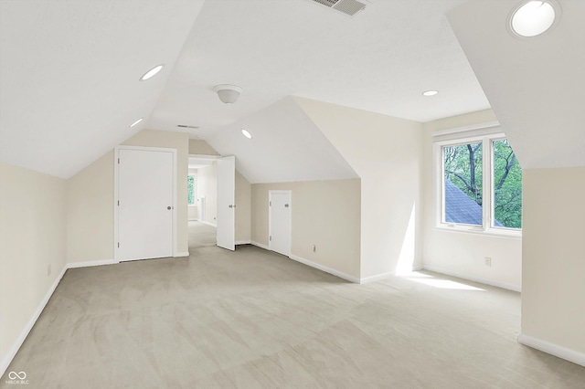 8602 Frontgate Ln, Indianapolis, IN 46256 - additional living space featuring light carpet, plenty of natural light, baseboards, vaulted ceiling, and recessed lighting