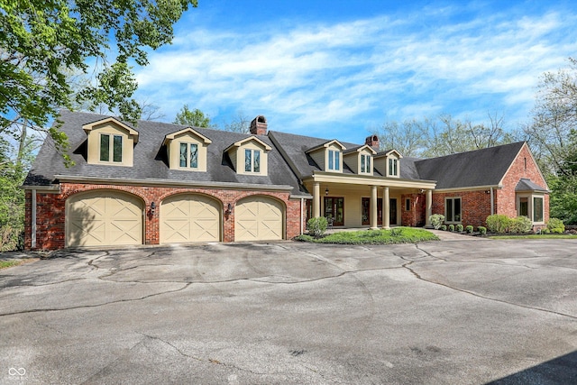 8602 Frontgate Ln, Indianapolis, IN 46256 - cape cod home with driveway, brick siding, and a chimney