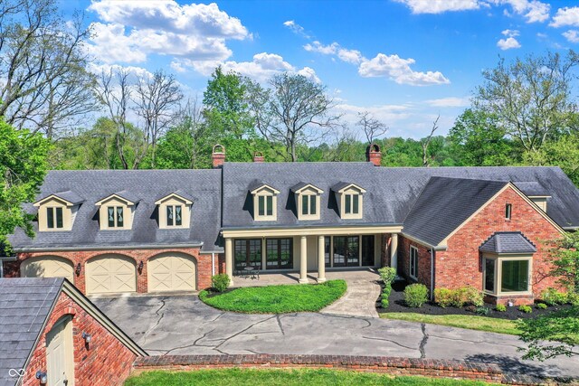 8602 Frontgate Ln, Indianapolis, IN 46256 - view of front of home featuring asphalt driveway, a chimney, brick siding, french doors, and a shingled roof