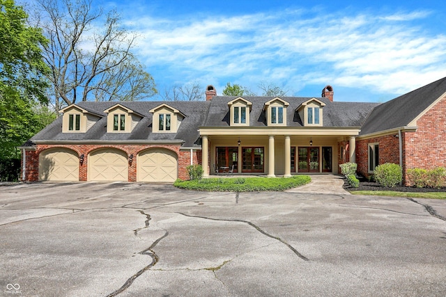 8602 Frontgate Ln, Indianapolis, IN 46256 - view of front of home featuring french doors, a chimney, driveway, and an attached garage