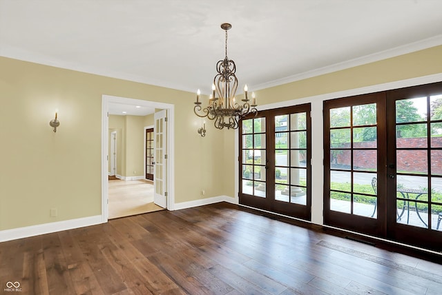 8602 Frontgate Ln, Indianapolis, IN 46256 - unfurnished dining area featuring french doors, a chandelier, hardwood / wood-style flooring, healthy amount of natural light, and crown molding