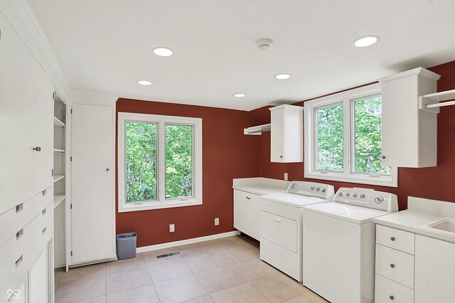8602 Frontgate Ln, Indianapolis, IN 46256 - laundry area with cabinet space, washing machine and clothes dryer, baseboards, recessed lighting, and light tile patterned floors