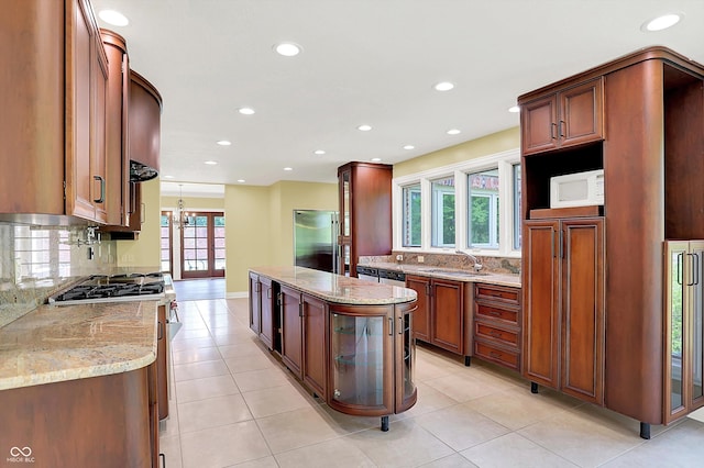 8602 Frontgate Ln, Indianapolis, IN 46256 - kitchen with appliances with stainless steel finishes, a sink, recessed lighting, light stone countertops, and decorative backsplash