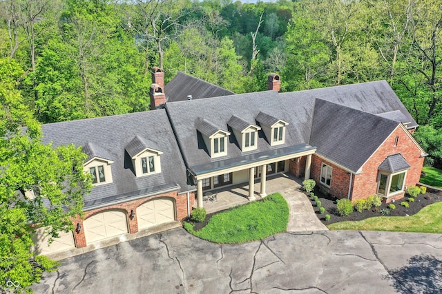 8602 Frontgate Ln, Indianapolis, IN 46256 - view of front of house with brick siding, a chimney, and asphalt driveway