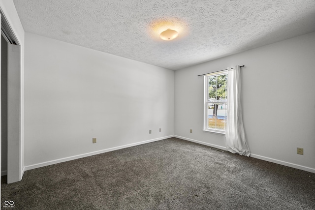 carpeted spare room with a textured ceiling