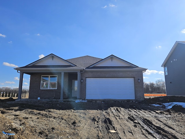 single story home with a garage and brick siding