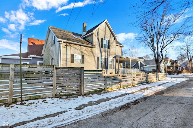 view of snow covered exterior featuring covered porch