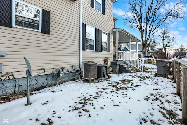 view of snowy exterior with central AC