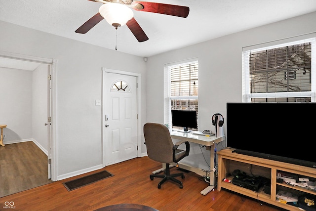 office area featuring dark wood-type flooring and ceiling fan