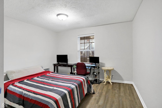 bedroom featuring hardwood / wood-style floors and a textured ceiling