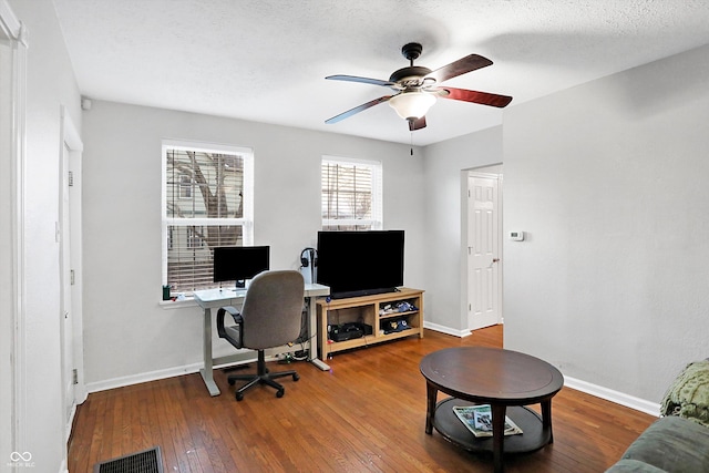 home office featuring ceiling fan, hardwood / wood-style floors, and a textured ceiling