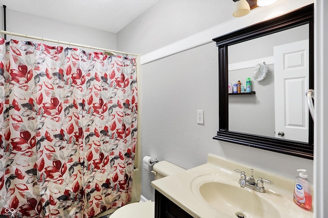 bathroom featuring vanity, toilet, and walk in shower