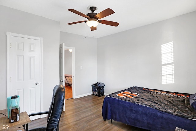 bedroom with dark hardwood / wood-style floors and ceiling fan