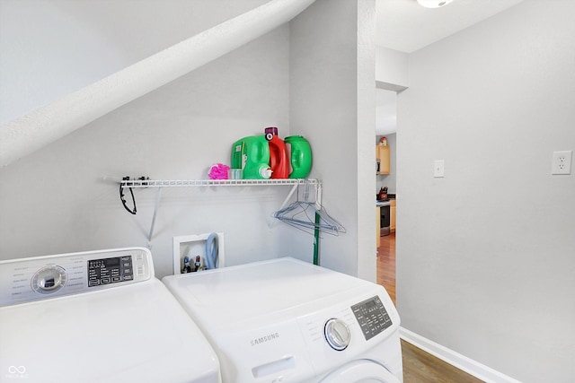 laundry room with wood-type flooring and separate washer and dryer