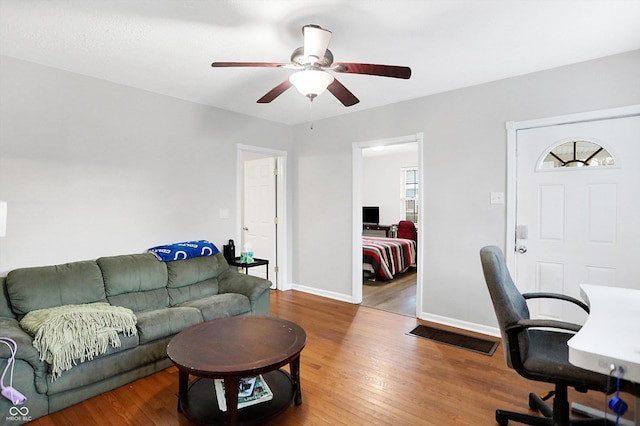 home office featuring a healthy amount of sunlight, hardwood / wood-style floors, and ceiling fan