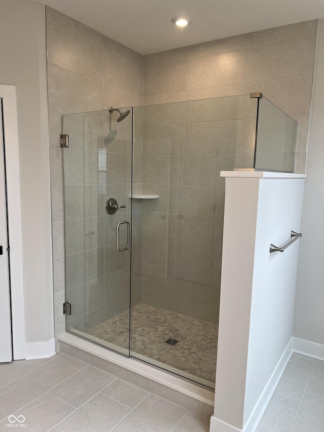 full bathroom with baseboards, recessed lighting, a stall shower, and tile patterned flooring