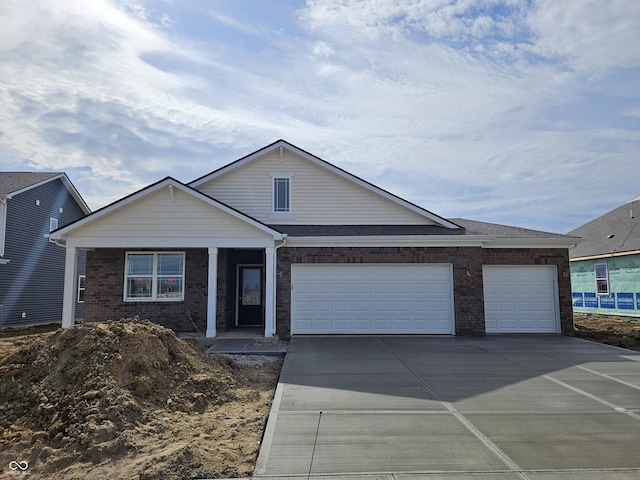 ranch-style home featuring concrete driveway, brick siding, and a garage