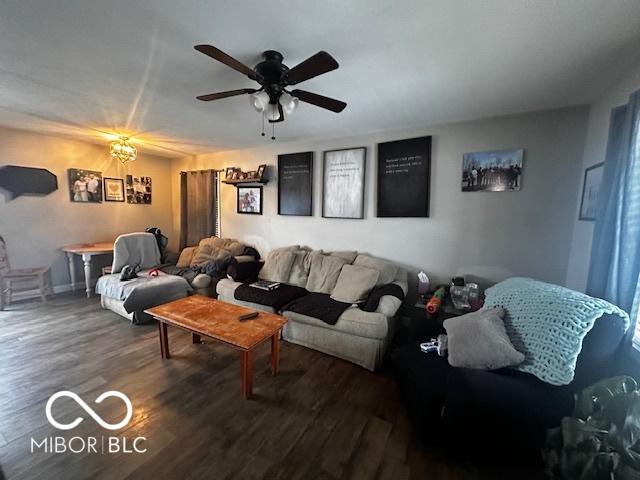 living room with dark hardwood / wood-style flooring and ceiling fan