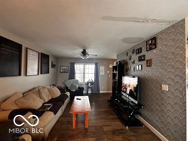 living room with ceiling fan and dark hardwood / wood-style flooring