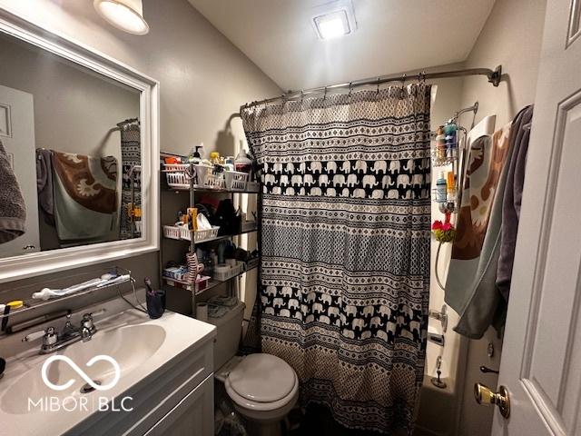 bathroom featuring vanity, toilet, and walk in shower