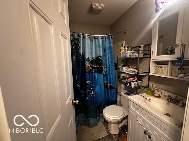 bathroom featuring vanity, tile patterned floors, toilet, and a shower with shower curtain