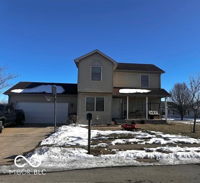 front of property featuring a garage and covered porch