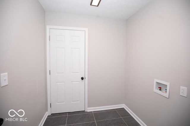 clothes washing area featuring washer hookup and dark tile patterned floors