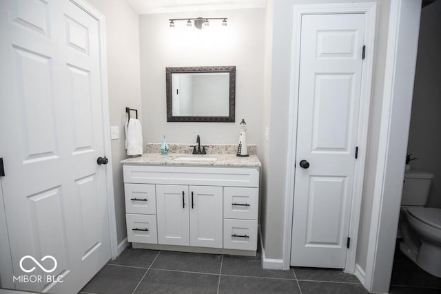 bathroom with tile patterned floors, toilet, and vanity