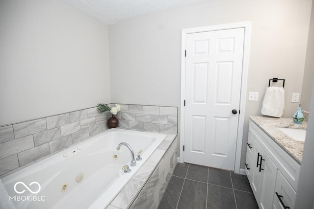 bathroom with tile patterned flooring, vanity, and a relaxing tiled tub