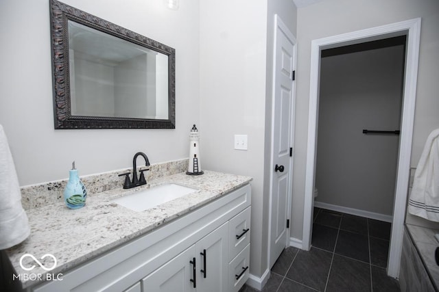 bathroom featuring vanity, tile patterned flooring, and toilet