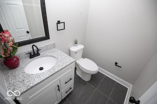 bathroom featuring tile patterned flooring, vanity, and toilet