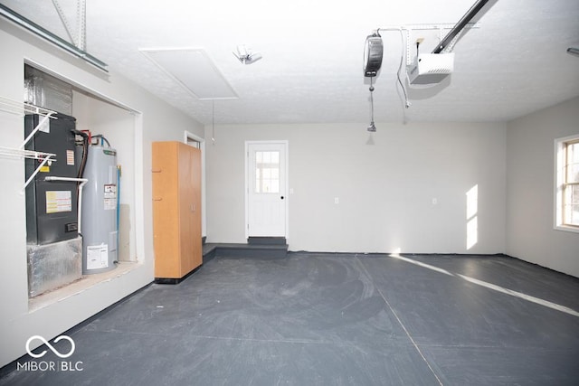 garage featuring heating unit, a garage door opener, and electric water heater