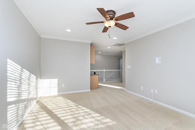 unfurnished living room featuring crown molding, light carpet, and ceiling fan