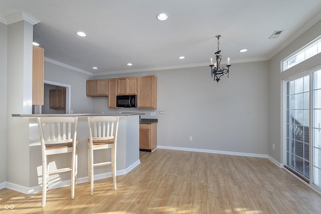 kitchen with light hardwood / wood-style flooring, ornamental molding, kitchen peninsula, a notable chandelier, and pendant lighting