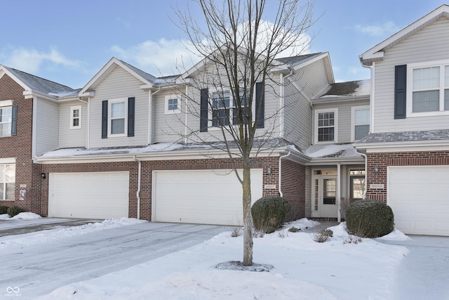 townhome / multi-family property featuring a garage