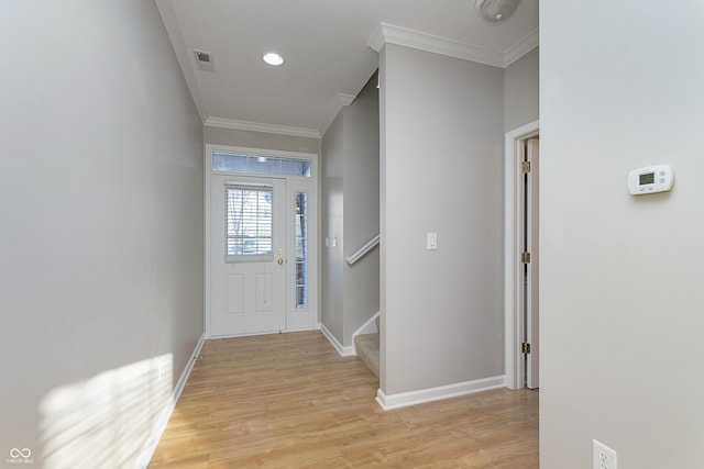 entryway featuring crown molding and light wood-type flooring