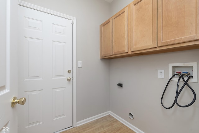 laundry area with cabinets, hookup for a washing machine, light hardwood / wood-style floors, and electric dryer hookup