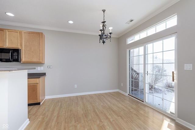 kitchen featuring crown molding, light brown cabinets, a notable chandelier, pendant lighting, and light hardwood / wood-style floors