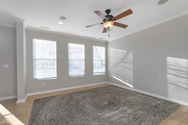 empty room with crown molding, ceiling fan, and light hardwood / wood-style flooring