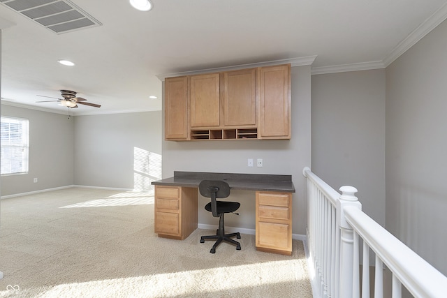 office space with crown molding, ceiling fan, and light carpet