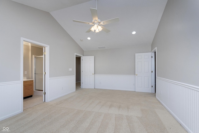 carpeted spare room with ceiling fan and lofted ceiling