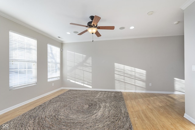 spare room with crown molding, ceiling fan, and light hardwood / wood-style flooring